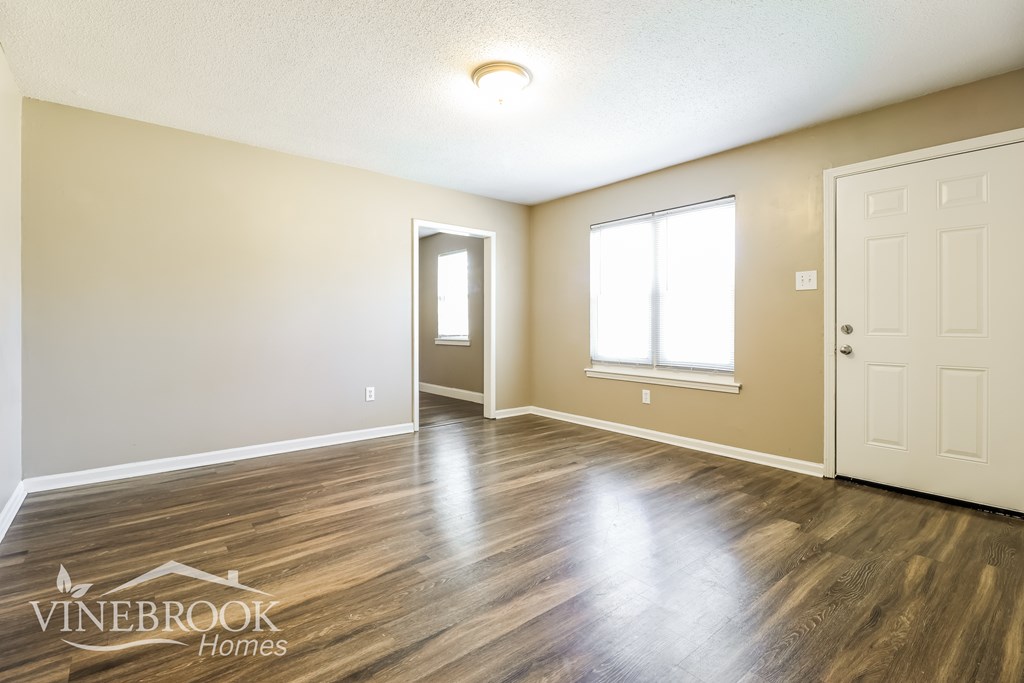 A room with a door, a window, and a logo that says Vinebrook Homes.
