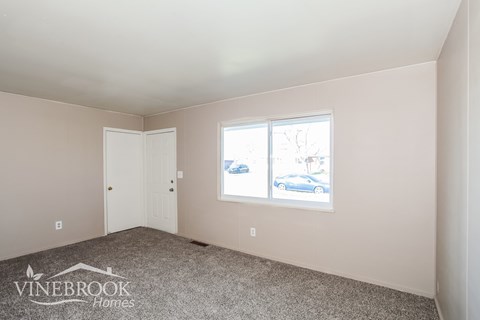 A room with a car on the window and a door on the left.