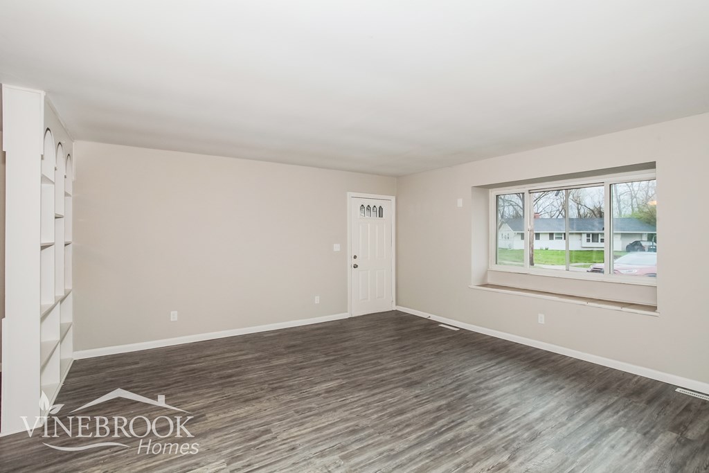 A room with a Vinebrook Homes logo on the floor.