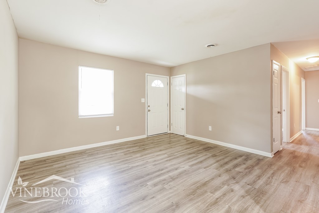 A room with wood flooring and a window is available for rent.