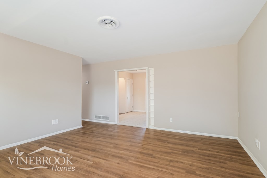 A room with a logo of Vinebrook Homes on the floor.