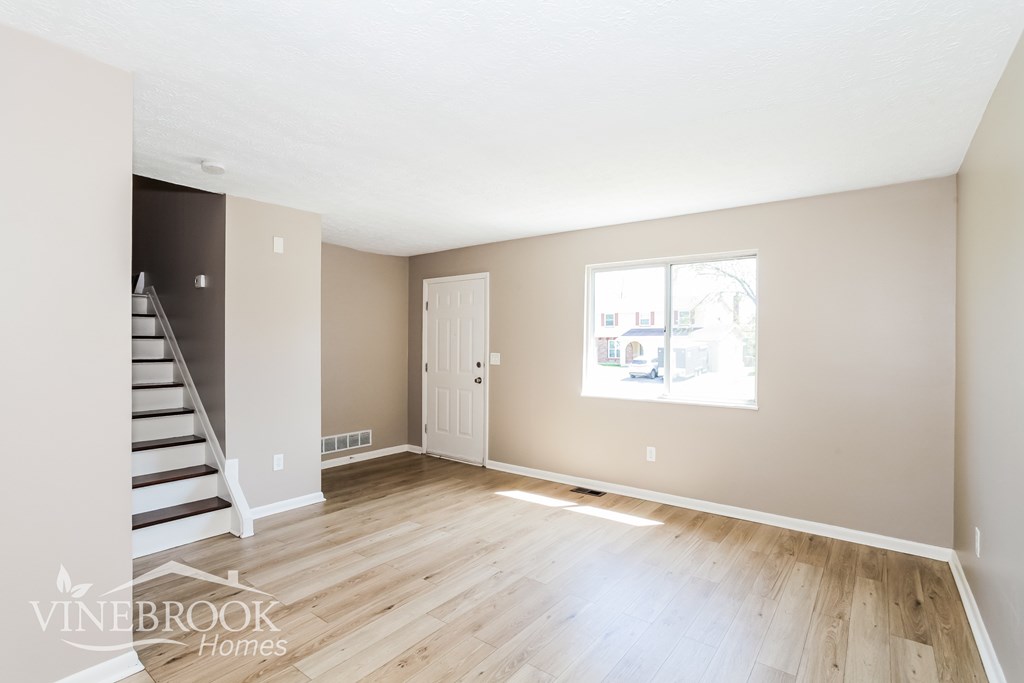A room with a staircase and a window.