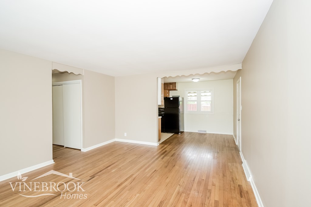 A room with wood flooring and a white ceiling.