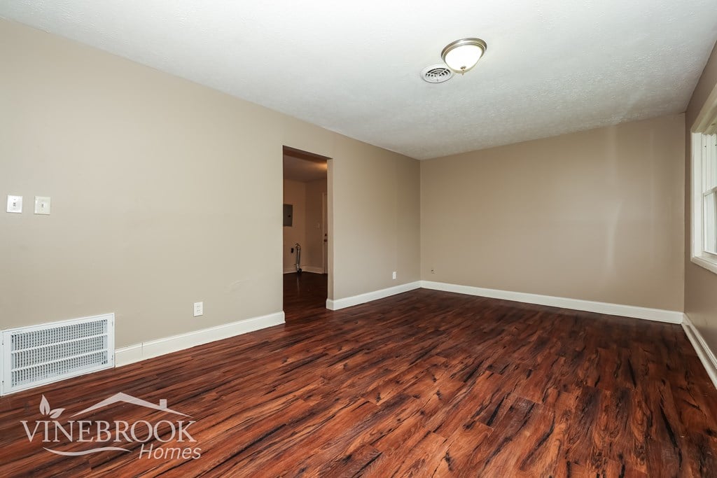 A room with wooden floors and a ceiling fan.