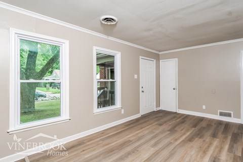 A room with a window and a door is shown.