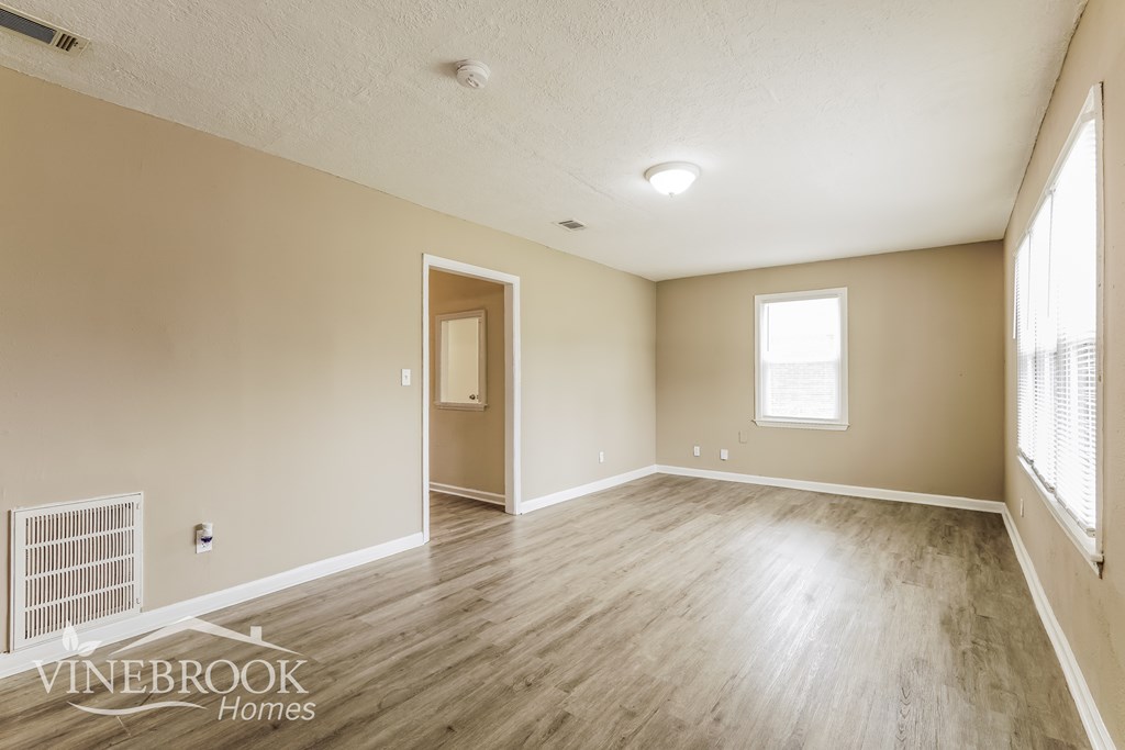 A room with a window and a door is shown.