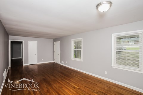 A room with a Vinebrook Homes logo on the floor.