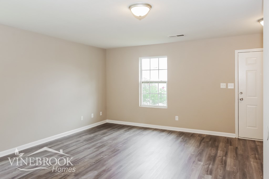 A room with a window and a door is on the market with Vinebrook Homes.