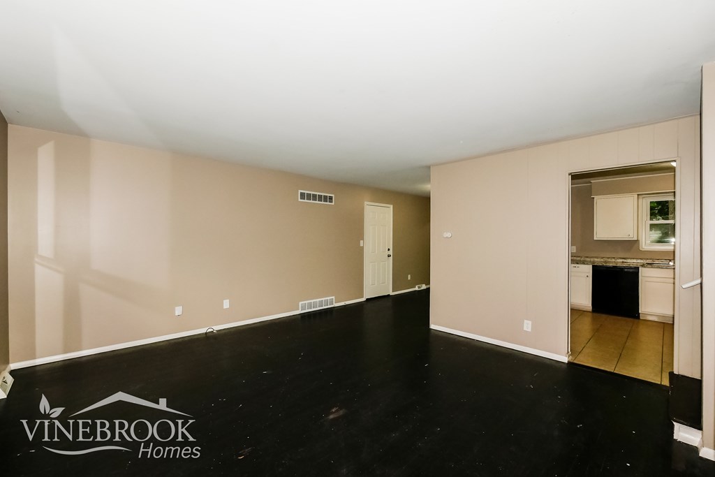 A room with a Vinebrook Homes logo on the floor.