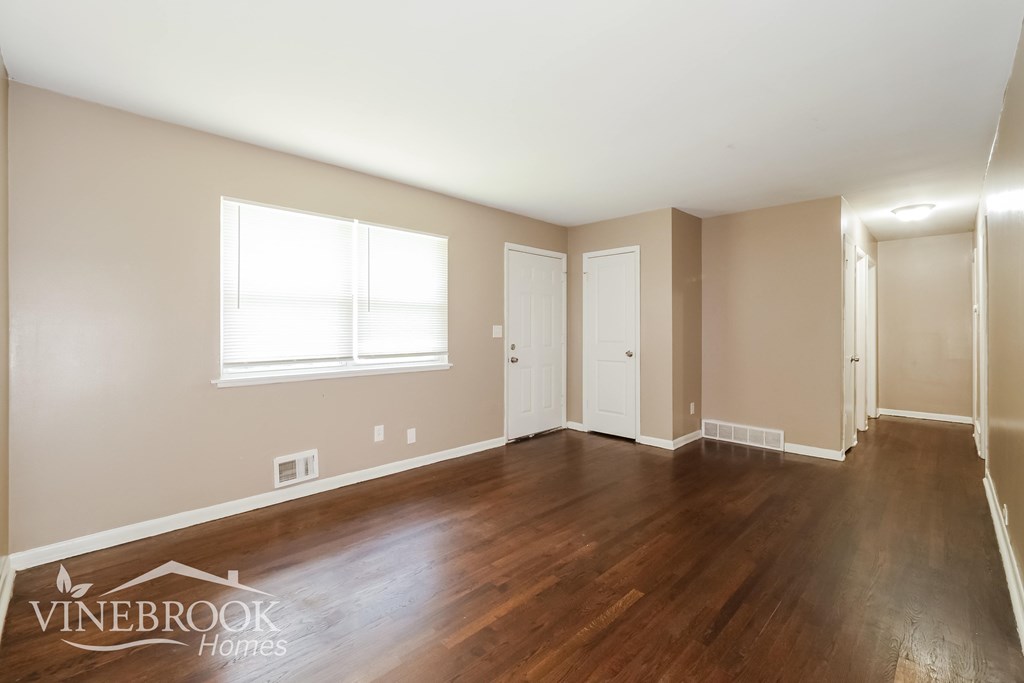 A room with wooden floors and white walls.