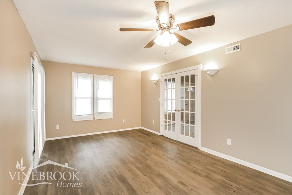 the living room is clean and ready to be used as a dining room