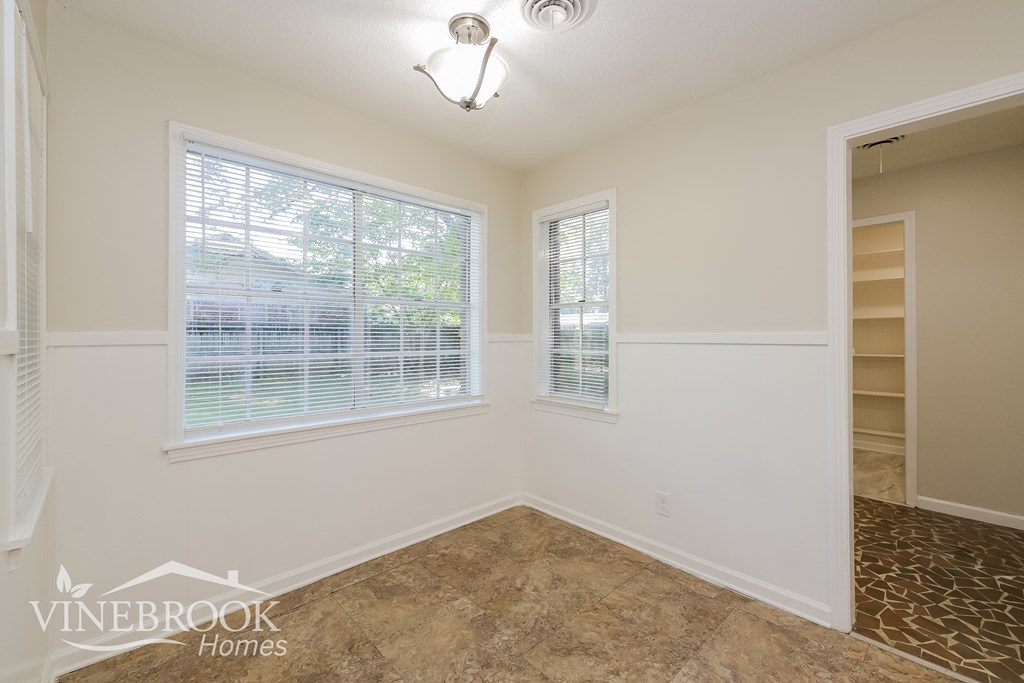 a empty room with a window and a closet