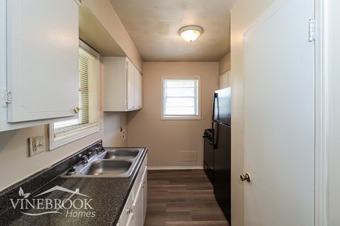 A kitchen with a sink and a window.