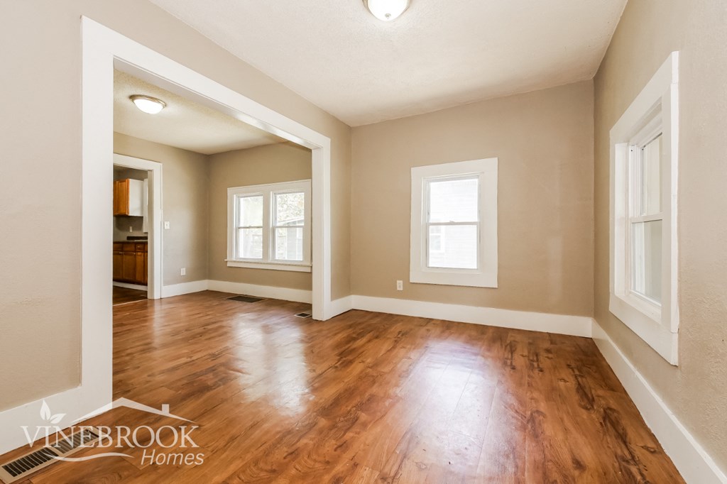 the living room and dining room with hardwood flooring