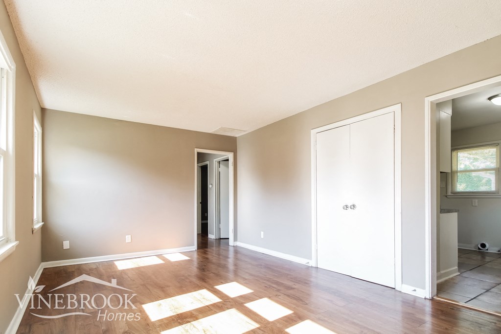 the living room is open to the dining room and kitchen