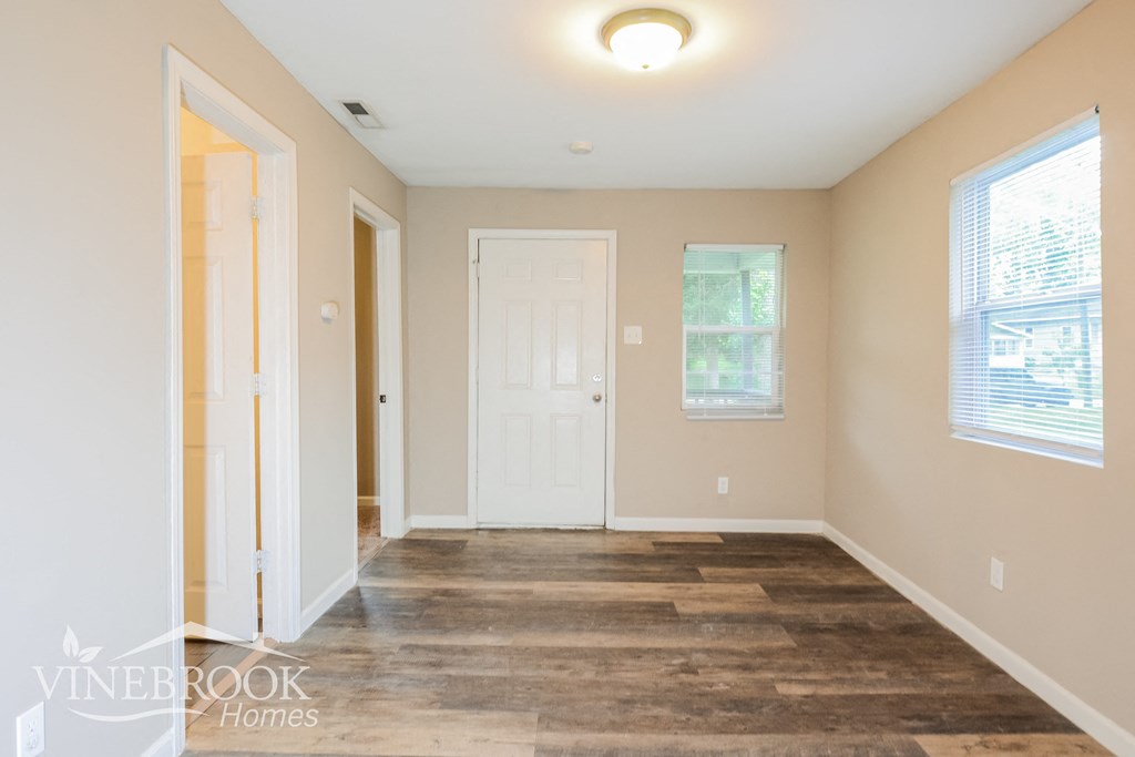 a living room with a wood floor and a white door