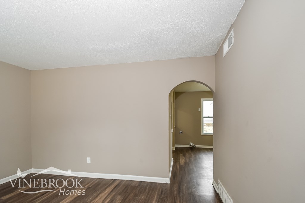 A room with a doorway leading to another room.