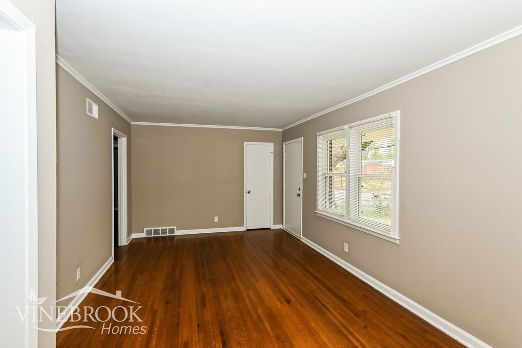 A room with wooden floors and white walls.