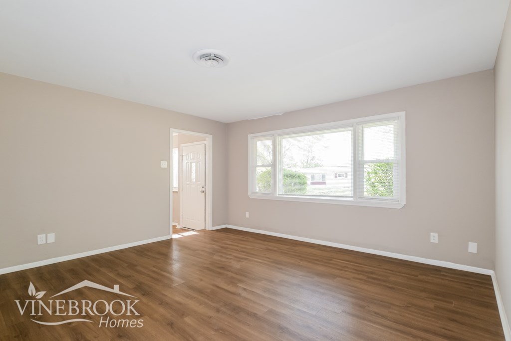 A room with a door and a window, with the words Vinebrook Homes on the bottom left.