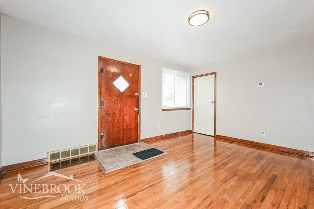 A room with a wooden floor and a door.