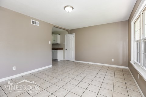A room with beige walls and a tiled floor.