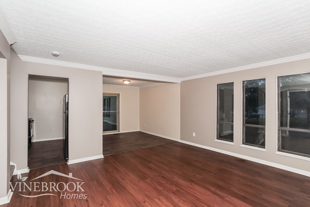 A room with a wooden floor and a white ceiling.