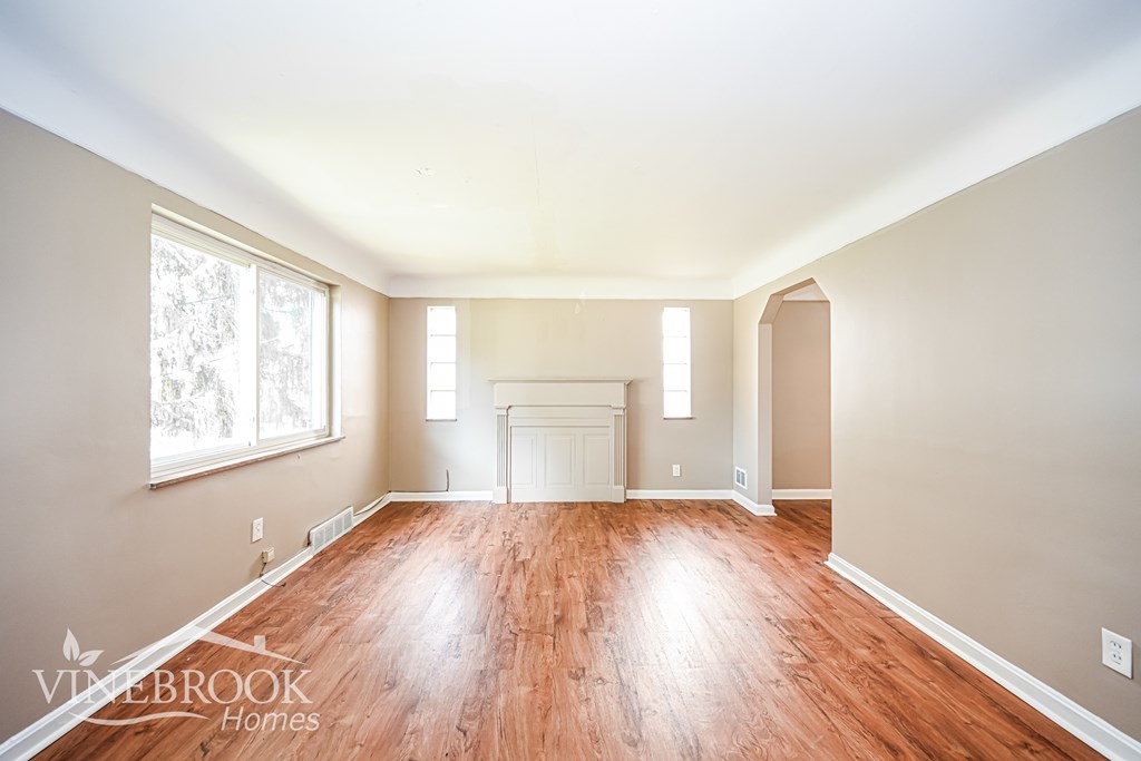 A room with wooden floors and white walls.