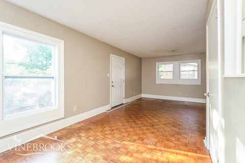 A room with a wooden floor and white walls.