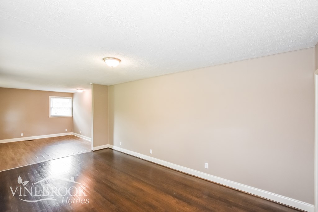 A room with a logo on the floor that says Vinebrook Homes.