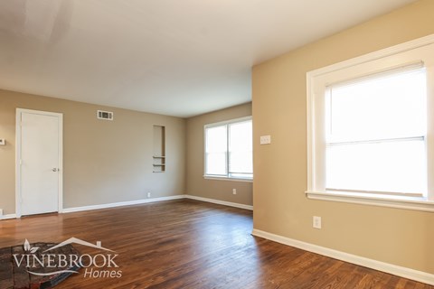 A room with a Vinebrook Homes logo on the floor.