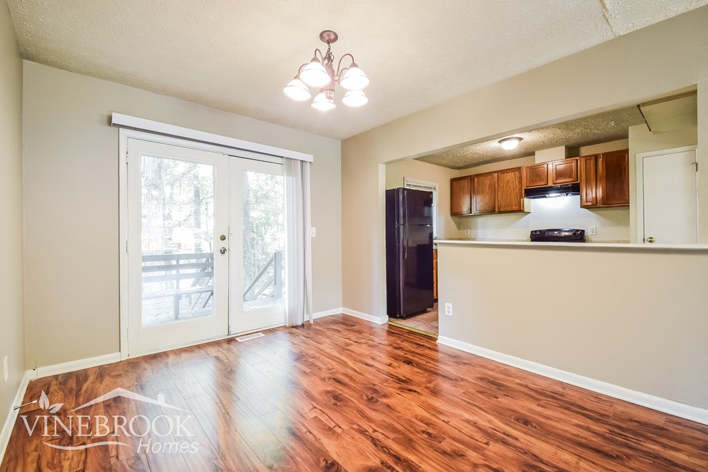 the living room is open to the dining room and kitchen