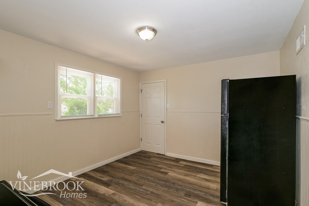 a bedroom with a closet and a door and a window