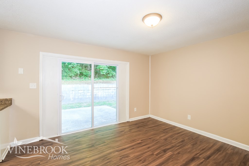 a living room with a hard wood floor and a window