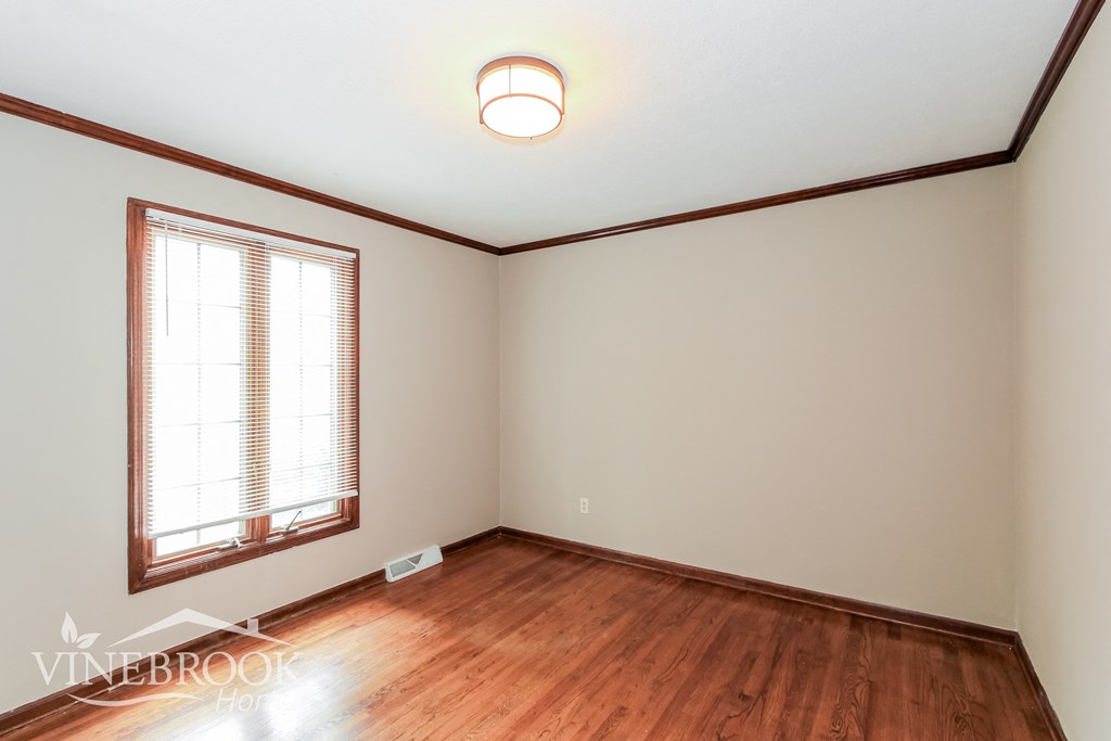 a living room with hardwood floors and a window