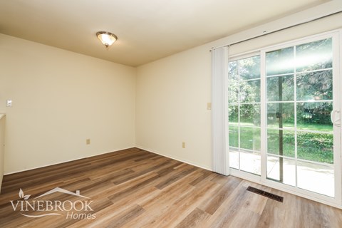 A room with a Vinebrook Homes logo on the floor.