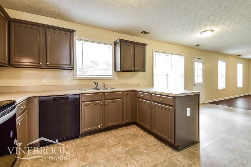 a kitchen with brown cabinets and a sink and a counter top