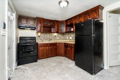 a kitchen with black appliances and wooden cabinets
