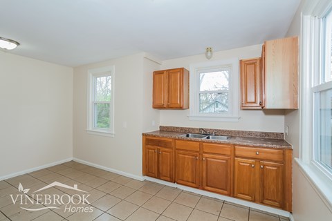 A kitchen with wooden cabinets and a countertop.