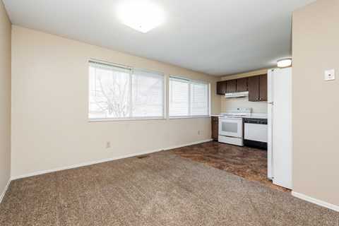 A kitchen area with a refrigerator, microwave, and oven.
