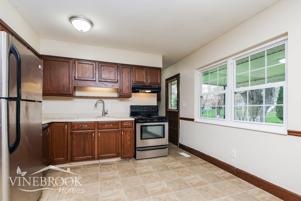 A kitchen with Vinebrook Homes logo.