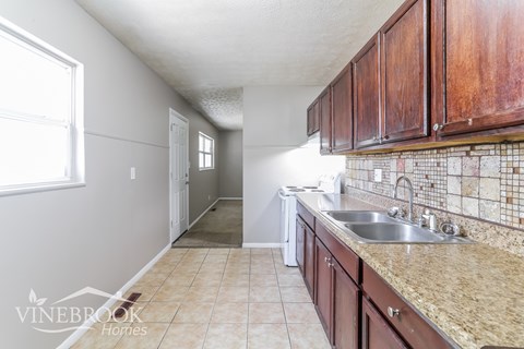 A kitchen with a sink and a window.