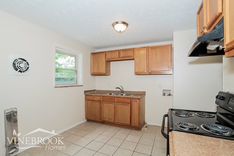 A kitchen with a Vinebrook Homes logo.