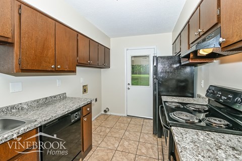 A kitchen with Vinebrook Homes logo.