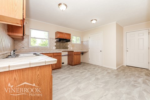 A kitchen with a Vinebrook Homes logo on the counter.
