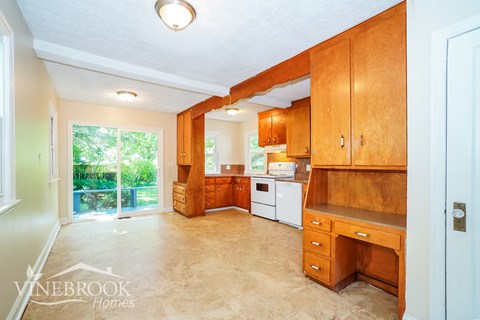 A kitchen with wooden cabinets and a countertop.