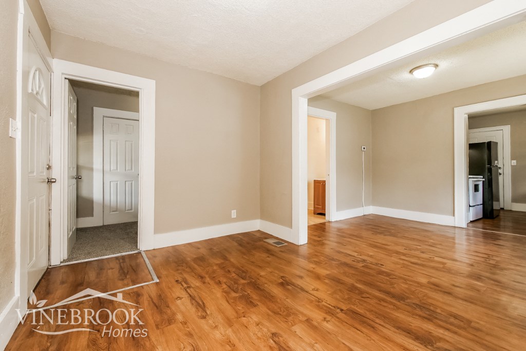the living room is open to the dining room and kitchen