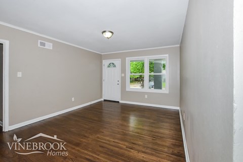 A room with a window and a door, branded with Vinebrook Homes.