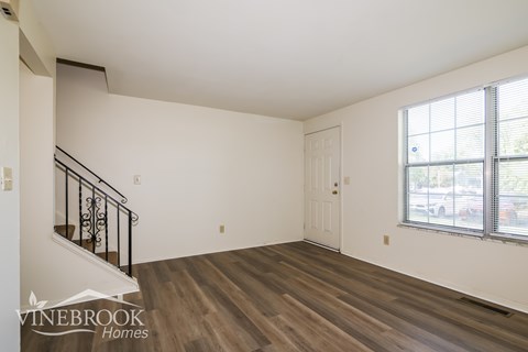 A room with a staircase and a window.