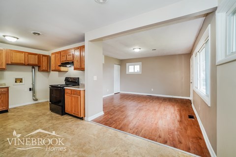 A kitchen with wooden cabinets and a black stove top oven.