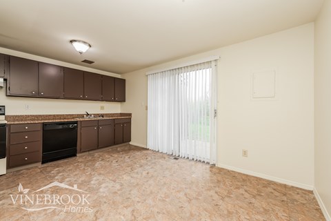 A kitchen with brown cabinets and a countertop is shown.
